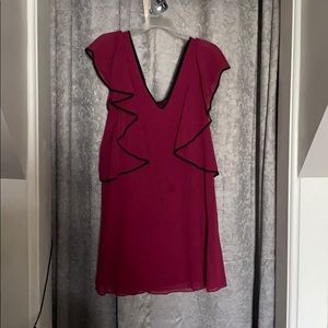 BCBG GENERATION red dress with black outline.